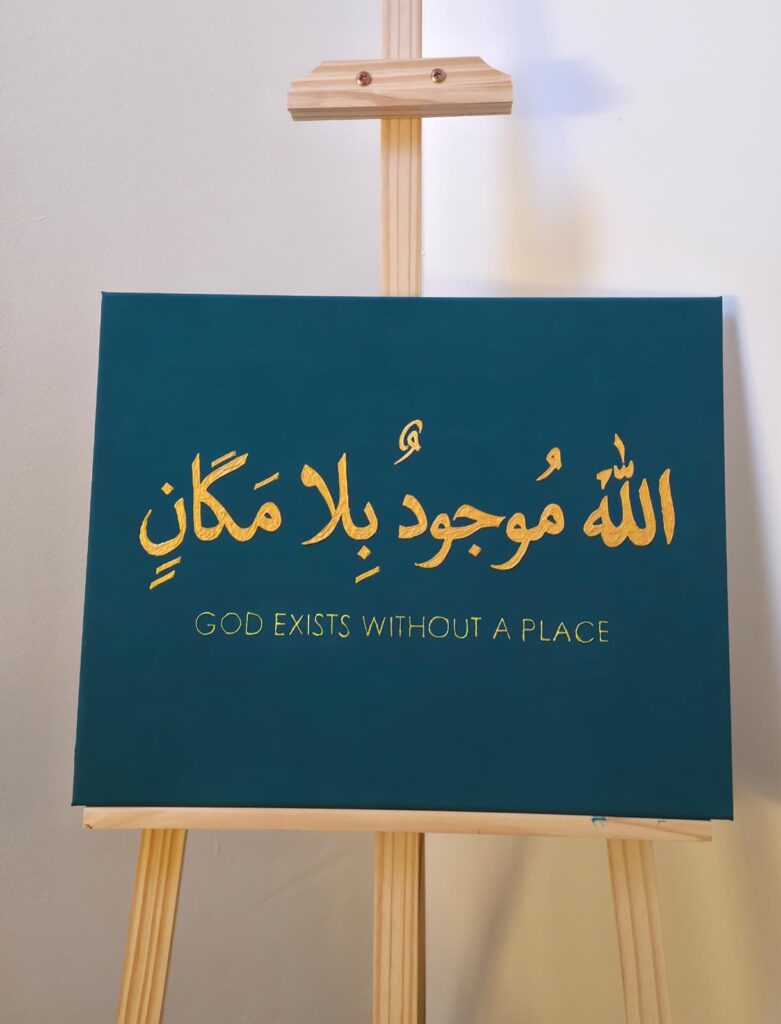 Hand-painted gold Arabic calligraphy on a deep teal canvas displayed on a wooden easel